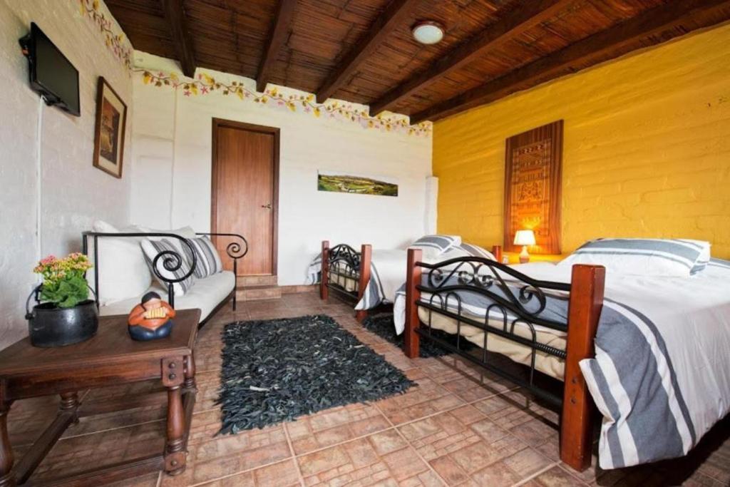 Postel nebo postele na pokoji v ubytování Hacienda El Rejo
