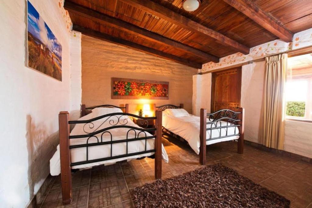 Postel nebo postele na pokoji v ubytování Hacienda El Rejo
