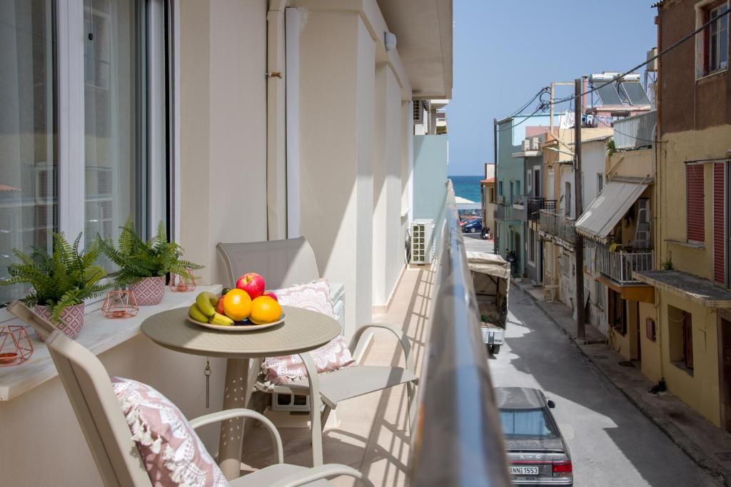 a bowl of fruit on a table on a balcony at Center Manolia Dream 3 Bedroom Apartment 100m away from the beach in Chania Town
