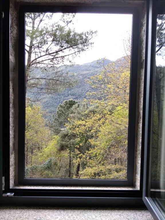 a window with a view of a mountain view at Casa Grilo in Geres