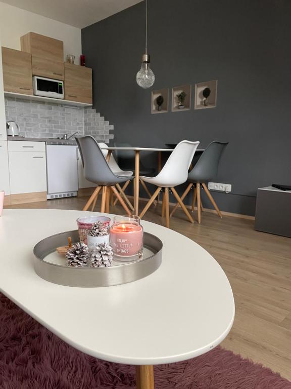 a living room with a white table and chairs at Dolní Morava - Apartmány in Dolní Morava
