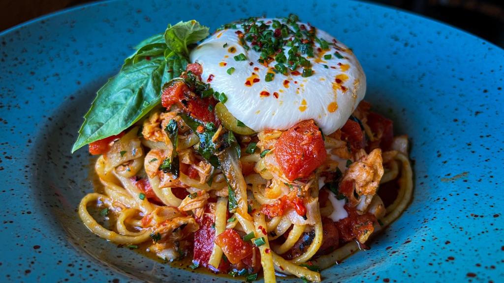 a plate of pasta with a poached egg on top at Slaymaker & Nichols Gastro House & Inn in Charlottetown