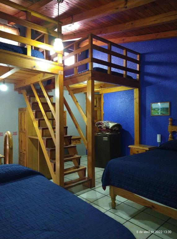 Postel nebo postele na pokoji v ubytování Hotel Plaza Mazamitla