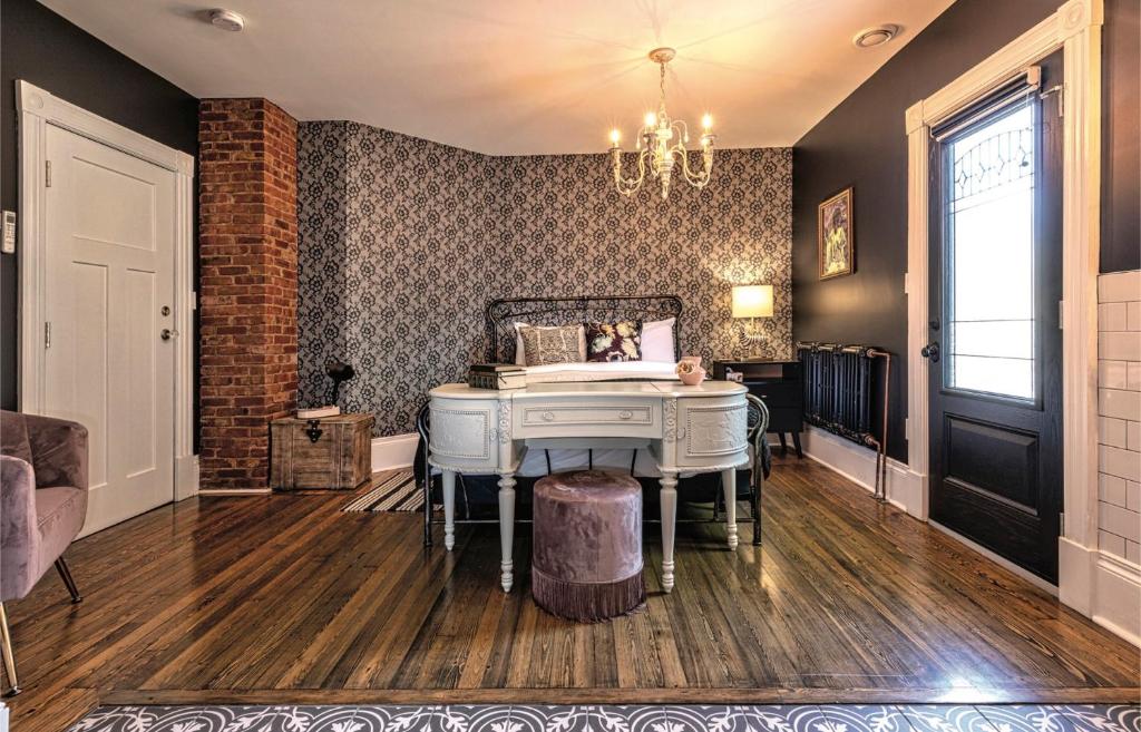 a room with a white piano in a room at Slaymaker & Nichols Gastro House & Inn in Charlottetown