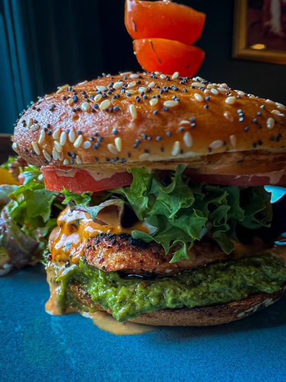 a large sandwich with lettuce and a sesame seed bun at Slaymaker & Nichols Gastro House & Inn in Charlottetown