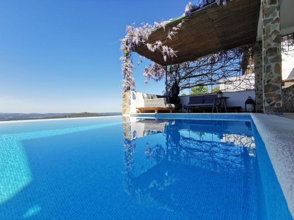 a swimming pool in front of a house at Casa BelaVista Penela - Charming Guest House - Adults Only in Penela