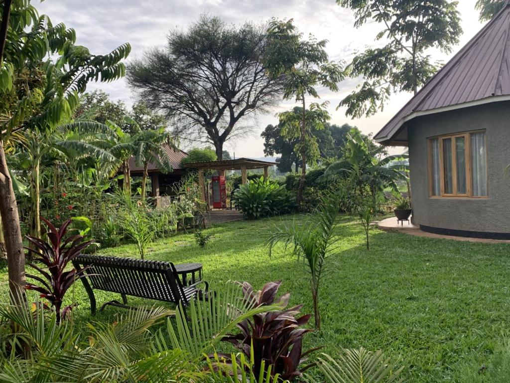 a park bench sitting in the middle of a yard at Tulivu Kilimanjaro Retreat in Msaranga