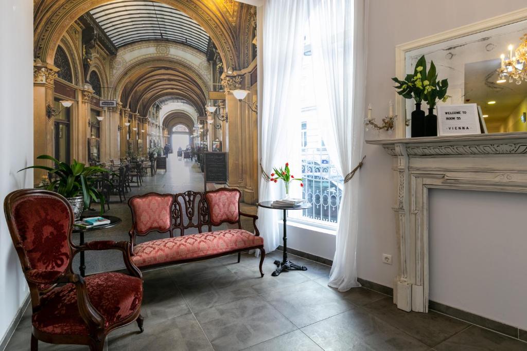 a hallway with chairs and a fireplace in a building at Room 55 in Vienna
