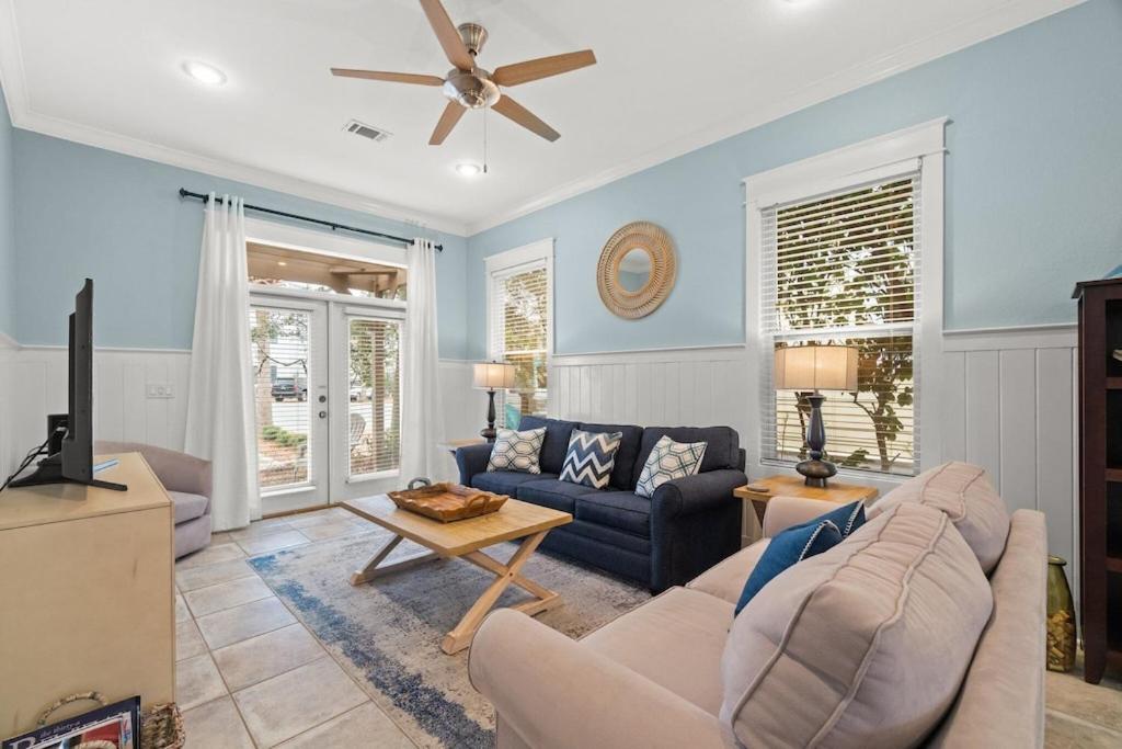 a living room with a couch and a ceiling fan at Aquanut Beach House 30A in Inlet Beach