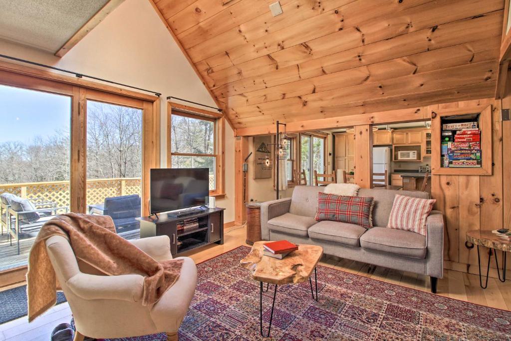 a living room with a couch and a tv at Storybook Stratton House 3 Mi to Mount Snow! in Stratton