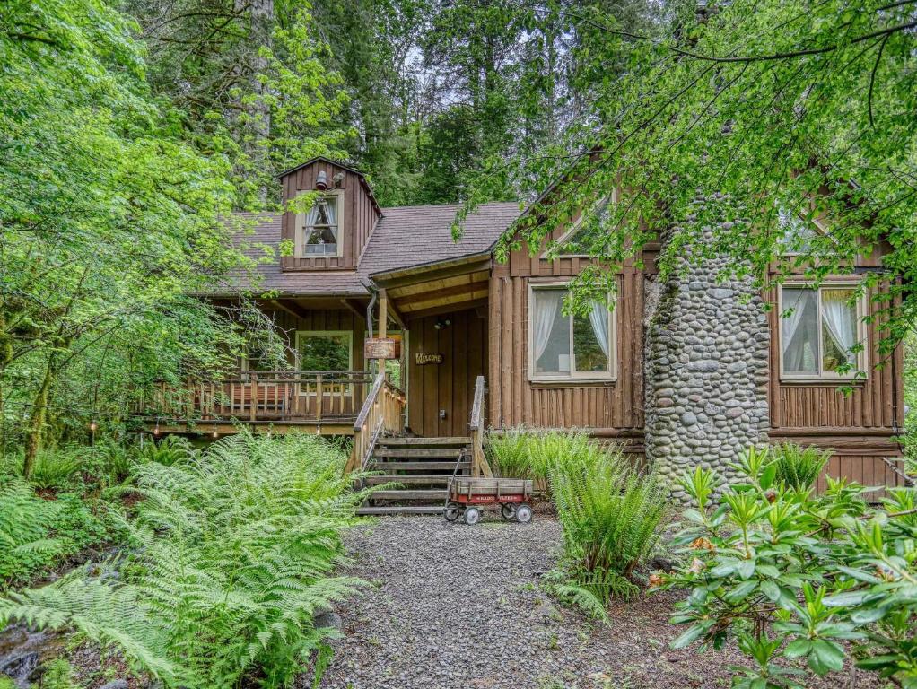 a wooden house with a porch and trees at Storybrooks Cabin - Meredith Lodging in Rhododendron