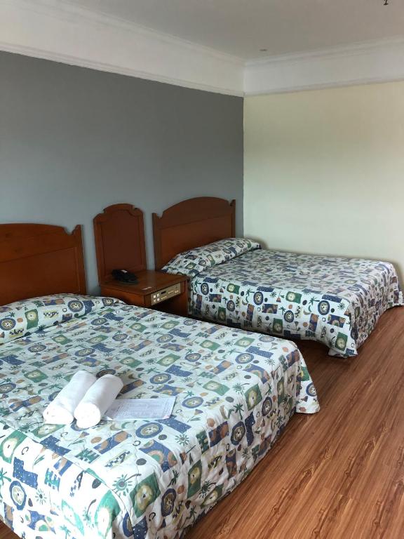 Postel nebo postele na pokoji v ubytování Purnama Hotel