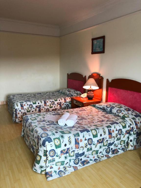 Postel nebo postele na pokoji v ubytování Purnama Hotel