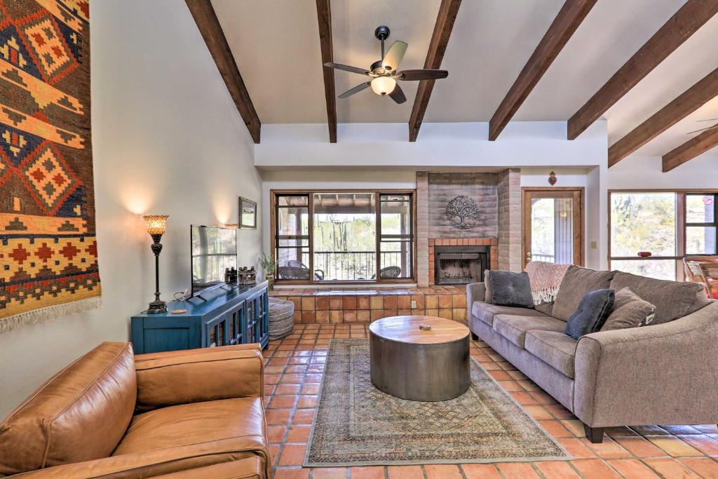 a living room with a couch and a table at Beautiful Saguaro Vista with Mountain Views! in Tucson