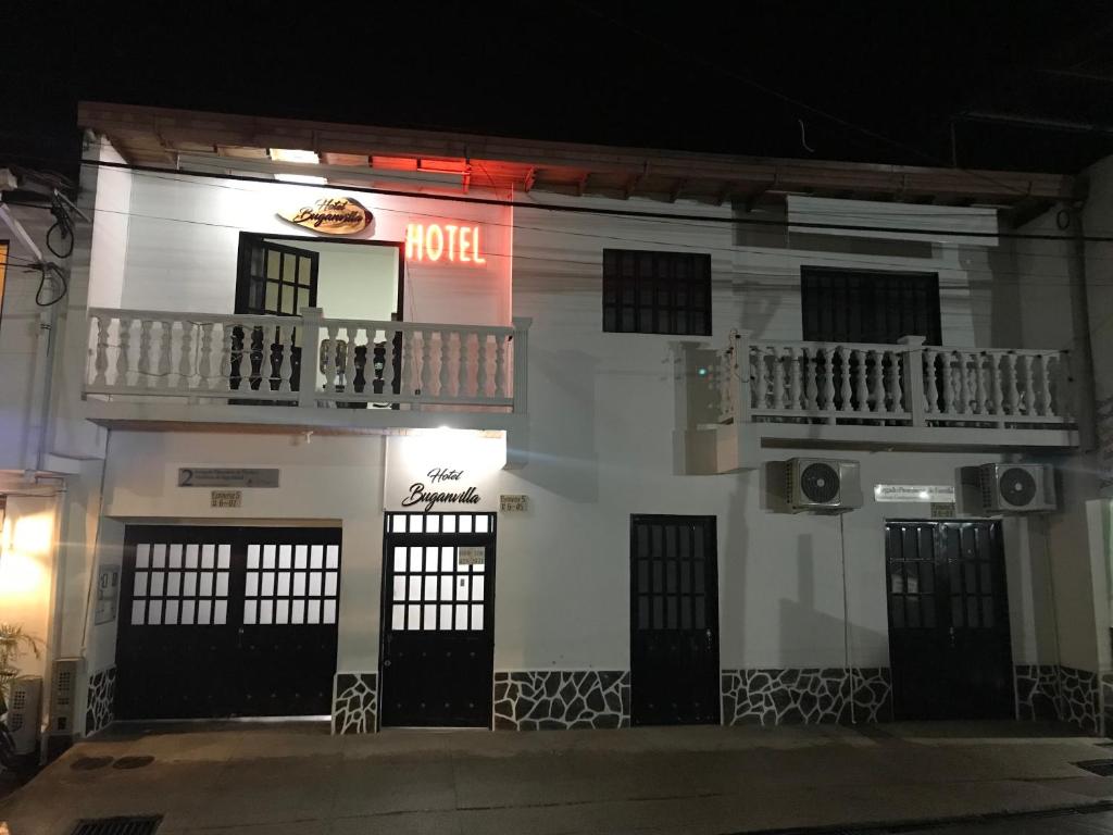 a building with a hotel sign on it at night at Hotel Buganvilla in Guaduas