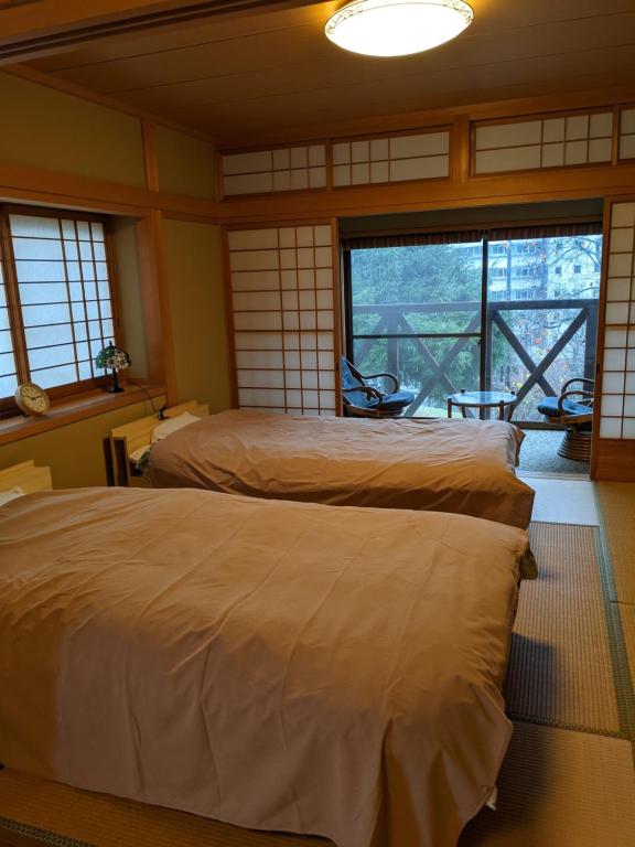 Postel nebo postele na pokoji v ubytování ワンコと泊まるジャスミンクリーク