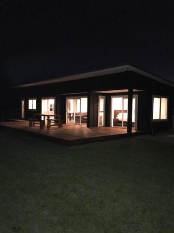 una casa di notte con un tavolo da picnic davanti di Dunray Cottage - Welcome to Havelock North a Hastings