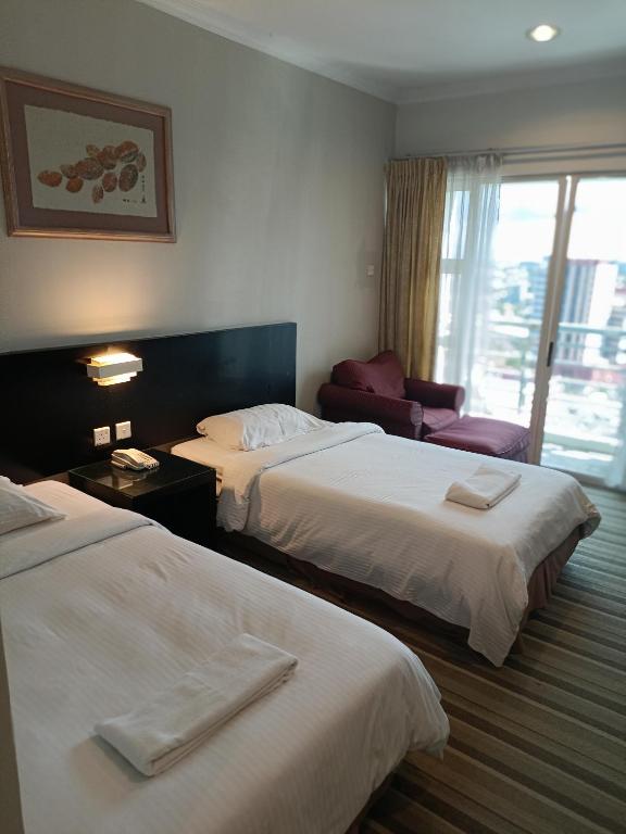Ένα ή περισσότερα κρεβάτια σε δωμάτιο στο StayInn Gateway Hotel Apartment