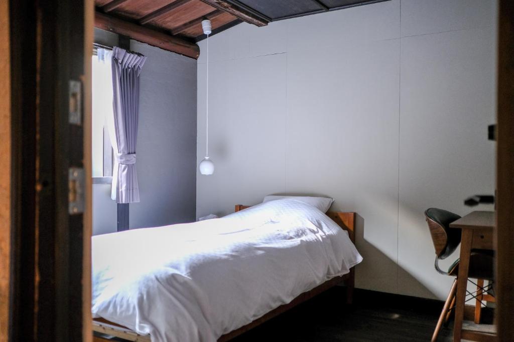 Postel nebo postele na pokoji v ubytování UNKNOWN KYOTO