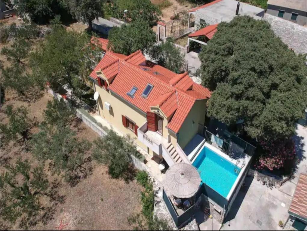 an aerial view of a house with a swimming pool at Villa Dore in Škrip