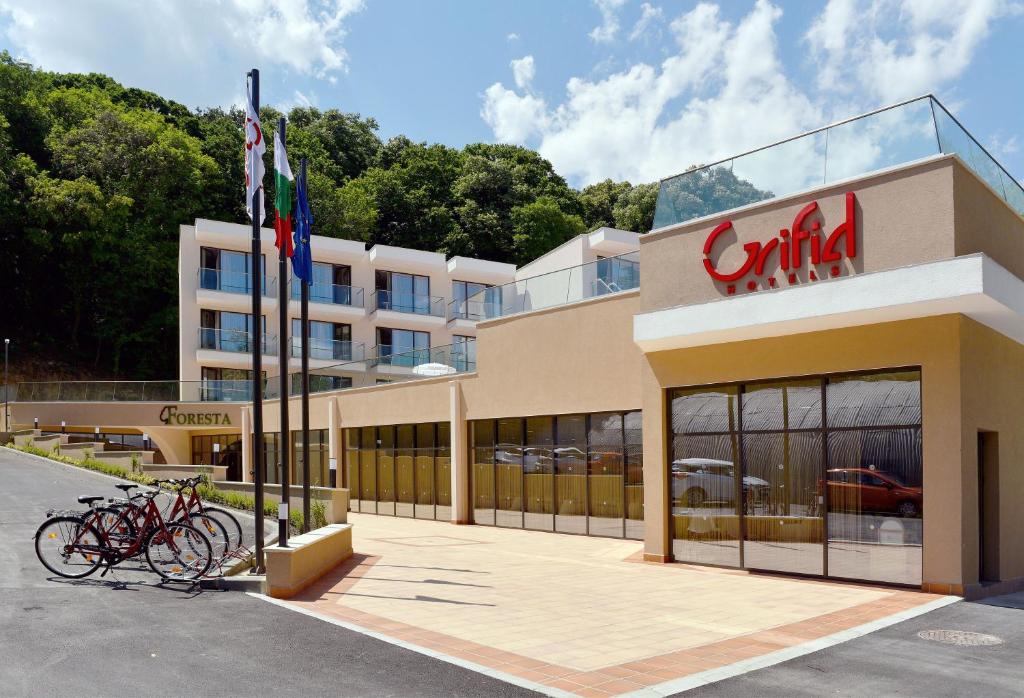 a building with bikes parked outside of it at GRIFID Hotel Foresta - All Inclusive & Free GRIFID Beach - Adults Only in Golden Sands