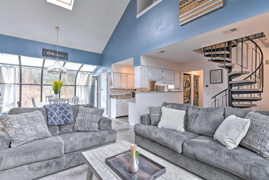 a living room with a couch and a table at Vernon Township Home with Deck on Golf Course in Vernon Township