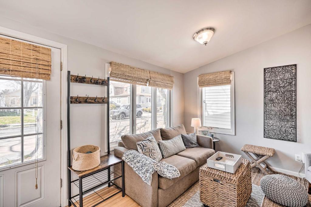 a living room with a couch and two windows at Bright Belmar Cottage Less Than Half Mi to Boardwalk! in Belmar