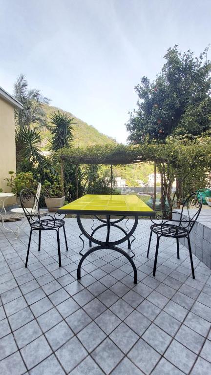 a ping pong table with two chairs on a patio at L'antico Giardino in Vietri sul Mare