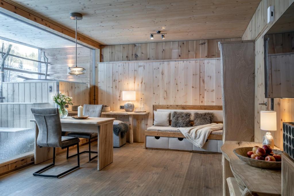 a living room filled with furniture and a fireplace at mama thresl in Leogang