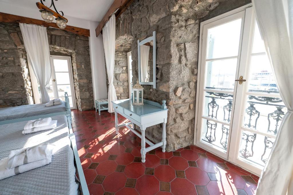 A bed or beds in a room at Dionysos Hotel