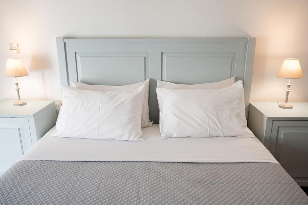 A bed or beds in a room at Dionysos Hotel