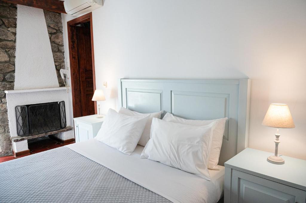 A bed or beds in a room at Dionysos Hotel