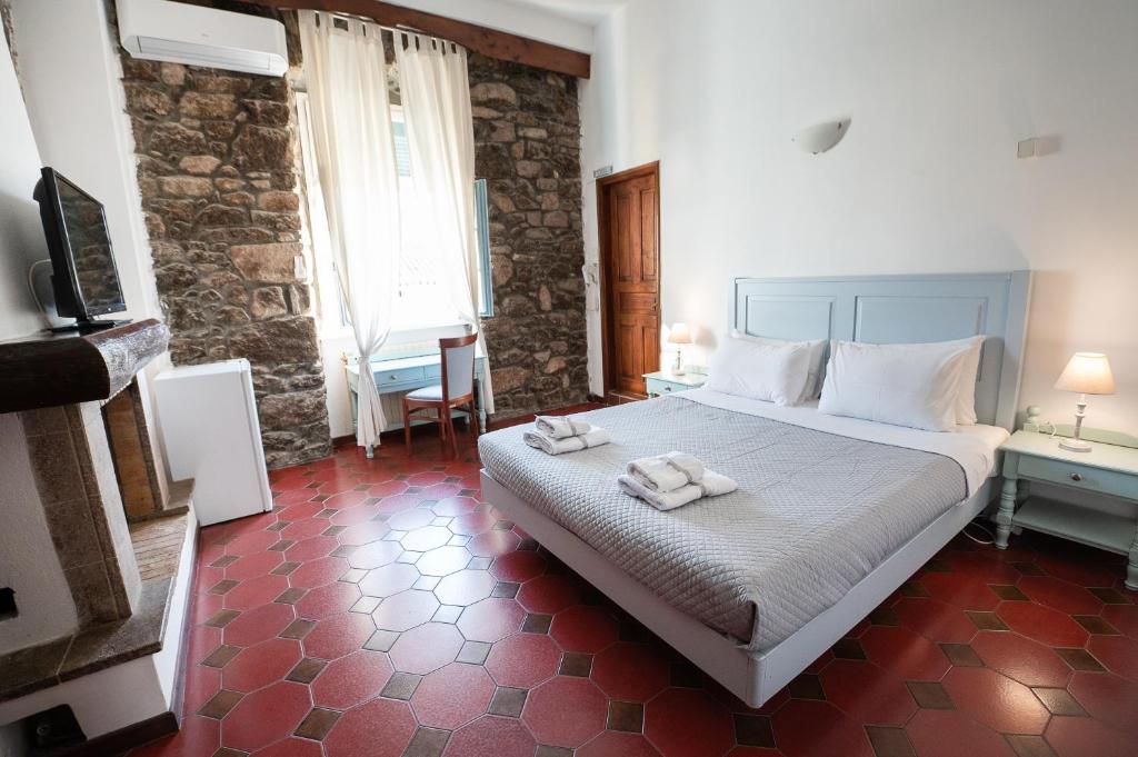 A bed or beds in a room at Dionysos Hotel