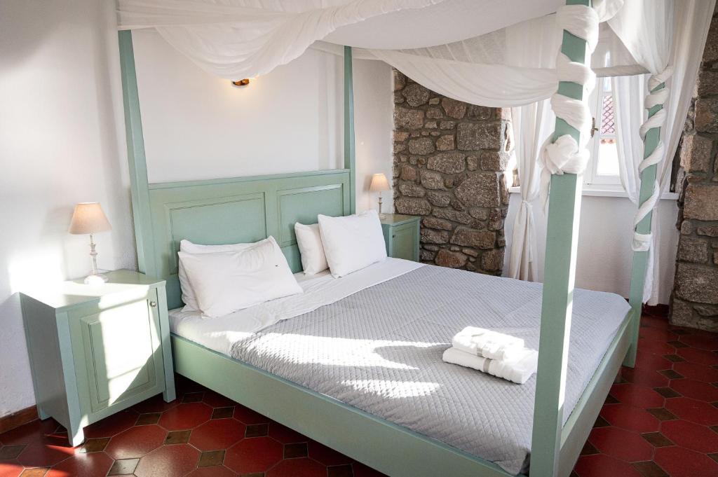A bed or beds in a room at Dionysos Hotel