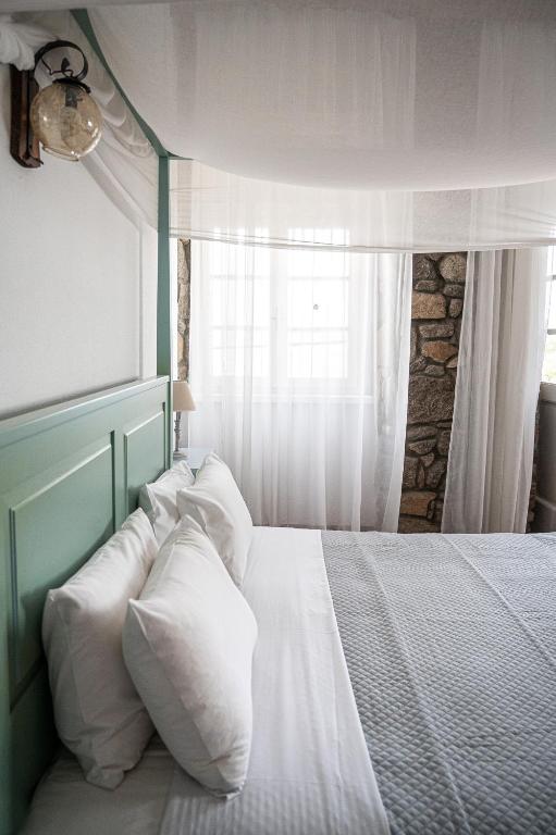 A bed or beds in a room at Dionysos Hotel
