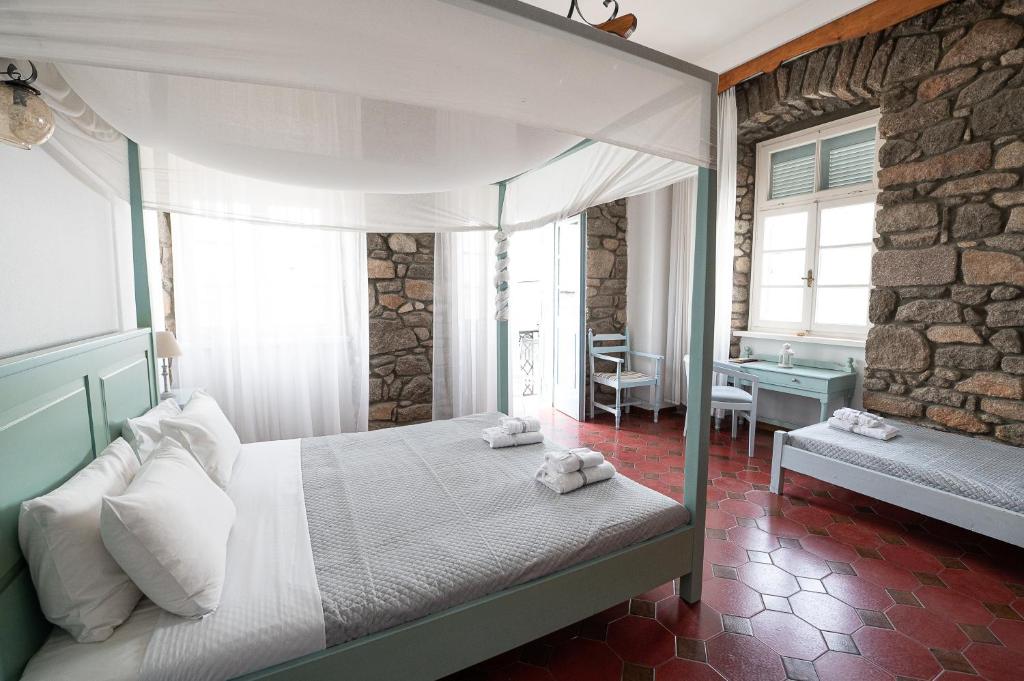 A bed or beds in a room at Dionysos Hotel