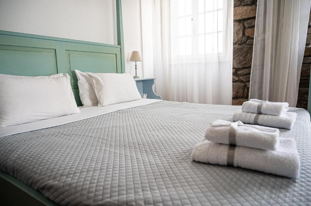 A bed or beds in a room at Dionysos Hotel