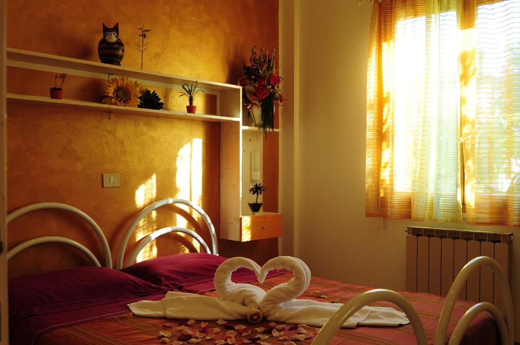 a bedroom with a bed with two hearts on it at Residence Ranieri in Castiglione del Lago