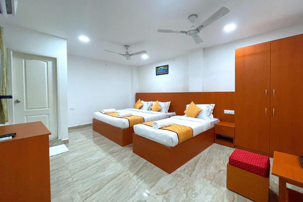 a bedroom with two beds and a dresser at K11 Express - Opp Express Avenue in Chennai