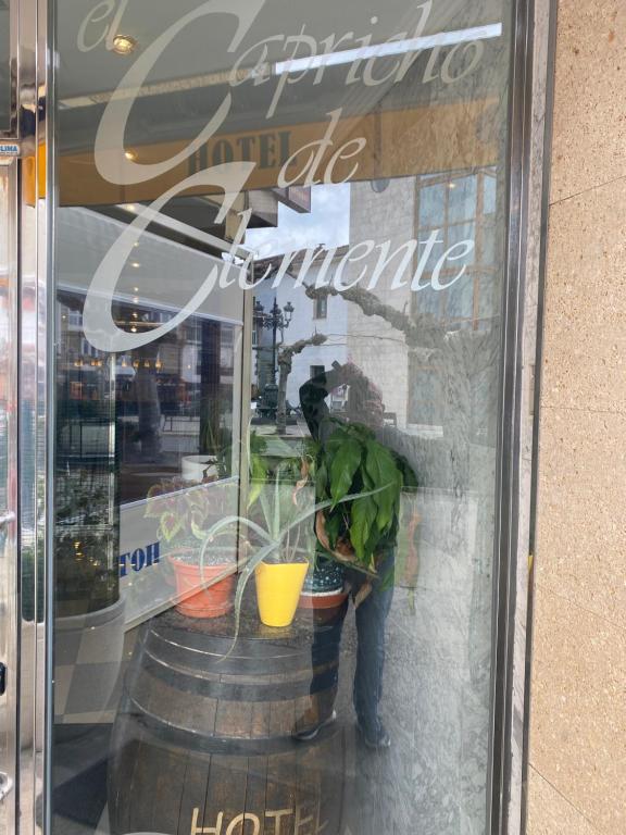 a reflection of a person in the window of a store at EL CAPRICHO DE CLEMENTE in Soncillo
