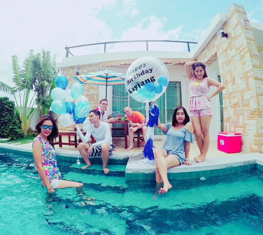 a group of people sitting in a swimming pool with balloons at Rocky Party Pool Villa Huahin 3 Bedrooom With BBQ & Karaoke in Hua Hin