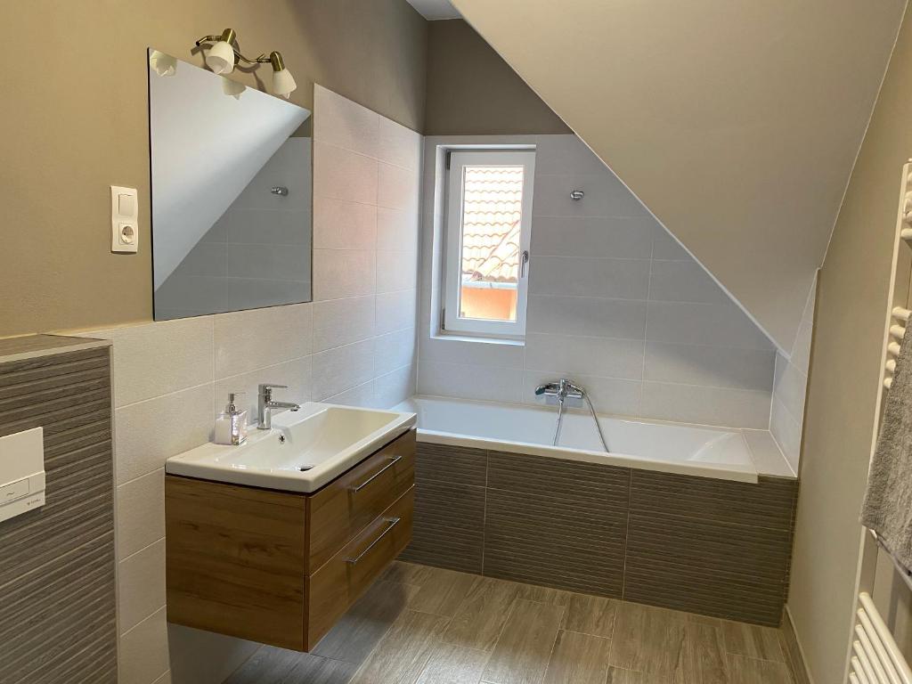 a bathroom with a sink and a bath tub at FENYŐ APARTMAN HOUSE II. in Odorheiu Secuiesc