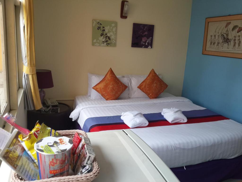 Postel nebo postele na pokoji v ubytování Sawasdee Sukhumvit Inn