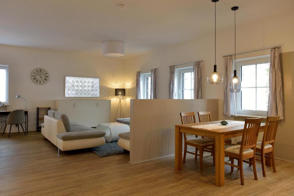 a living room with a table and a dining room at Ferienwohnung Sicado Loft in Aschau im Chiemgau