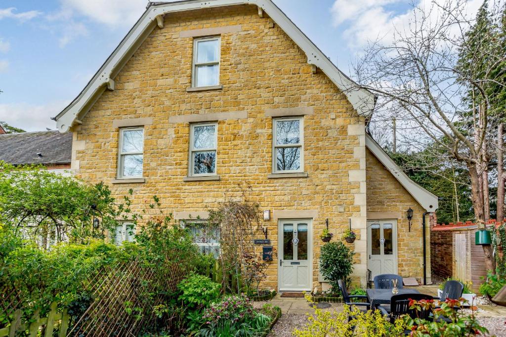a brick house with a white door at Jasmine Cottage in Chipping Campden