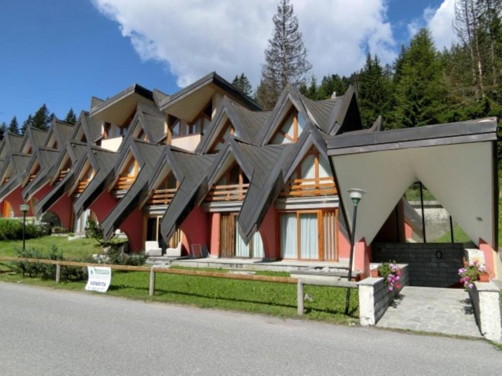 a house with black roof at Alberti - Condominio Villa Golf in Madonna di Campiglio