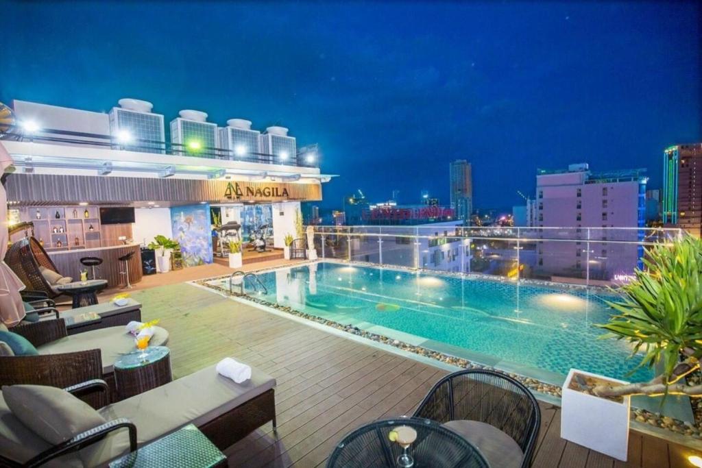 a swimming pool on the roof of a building at Nagila Boutique Hotel in Da Nang