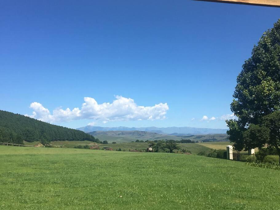 a field of green grass with mountains in the background at Number 10 in Nottingham Road