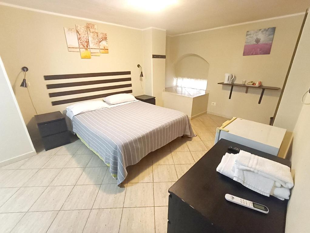 a bedroom with a bed and a table in it at Guest House Albergabici La Cattedrale in Barletta