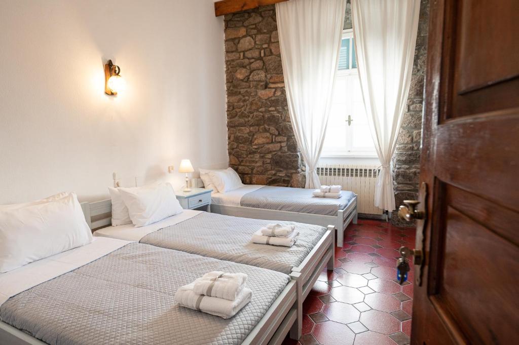 A bed or beds in a room at Dionysos Hotel